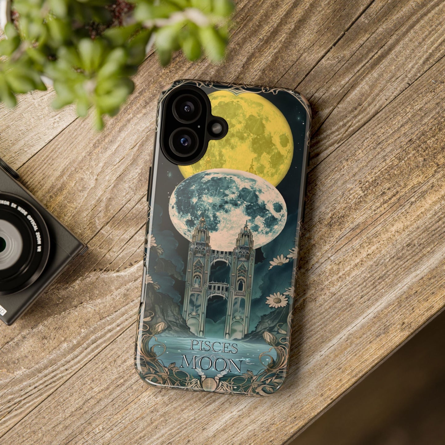 Pisces "The Moon" Tarot Card Phone Case on a wooden table.