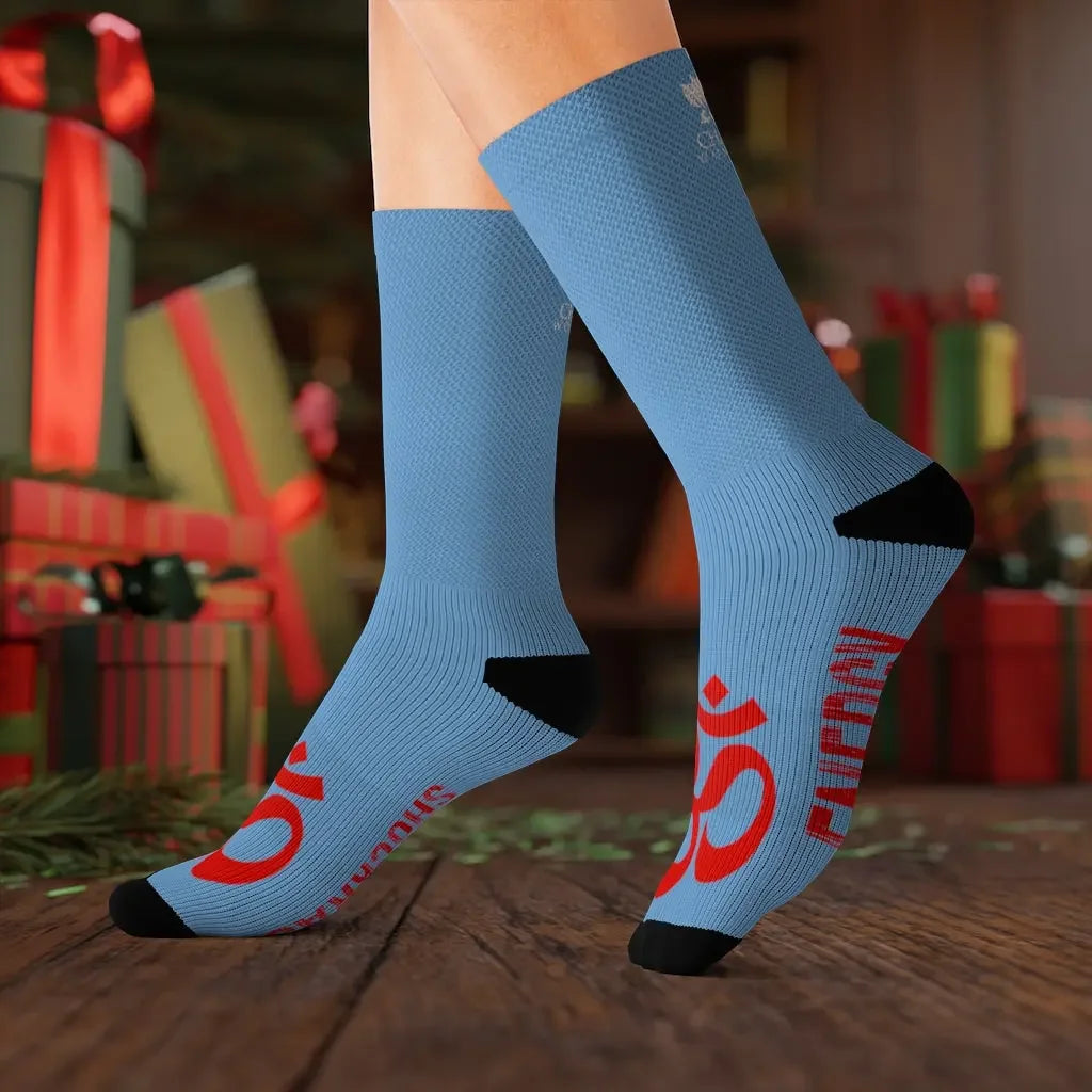 Blue chakra socks with red Om symbol, festive holiday background