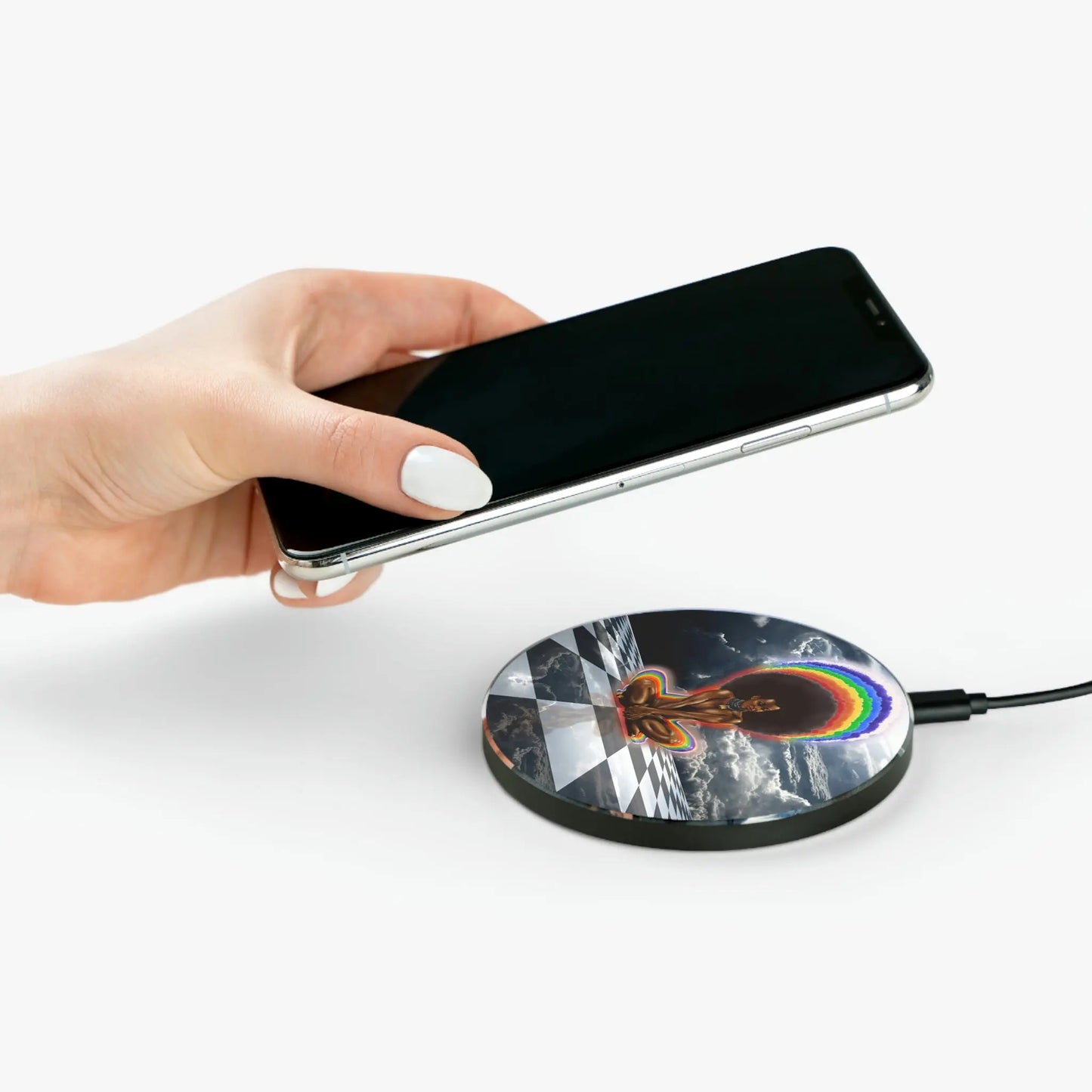 Person placing a phone onto the "Black Girl Magic" Wireless Charger.