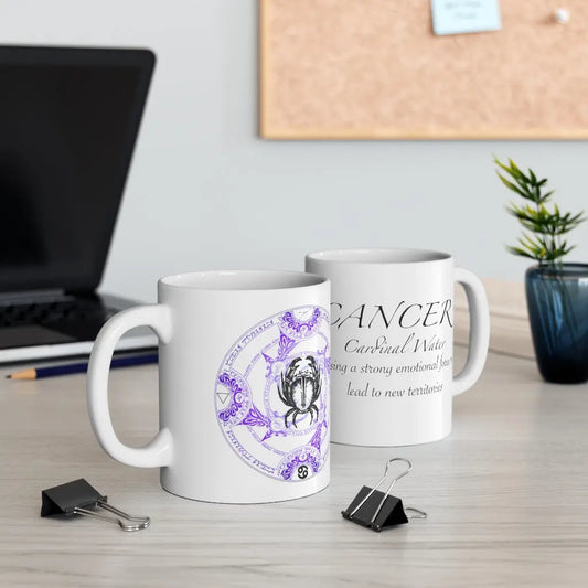 Two Cancer Zodiac Mugs on a desk, showing both the quote side and the elemental sigil side.