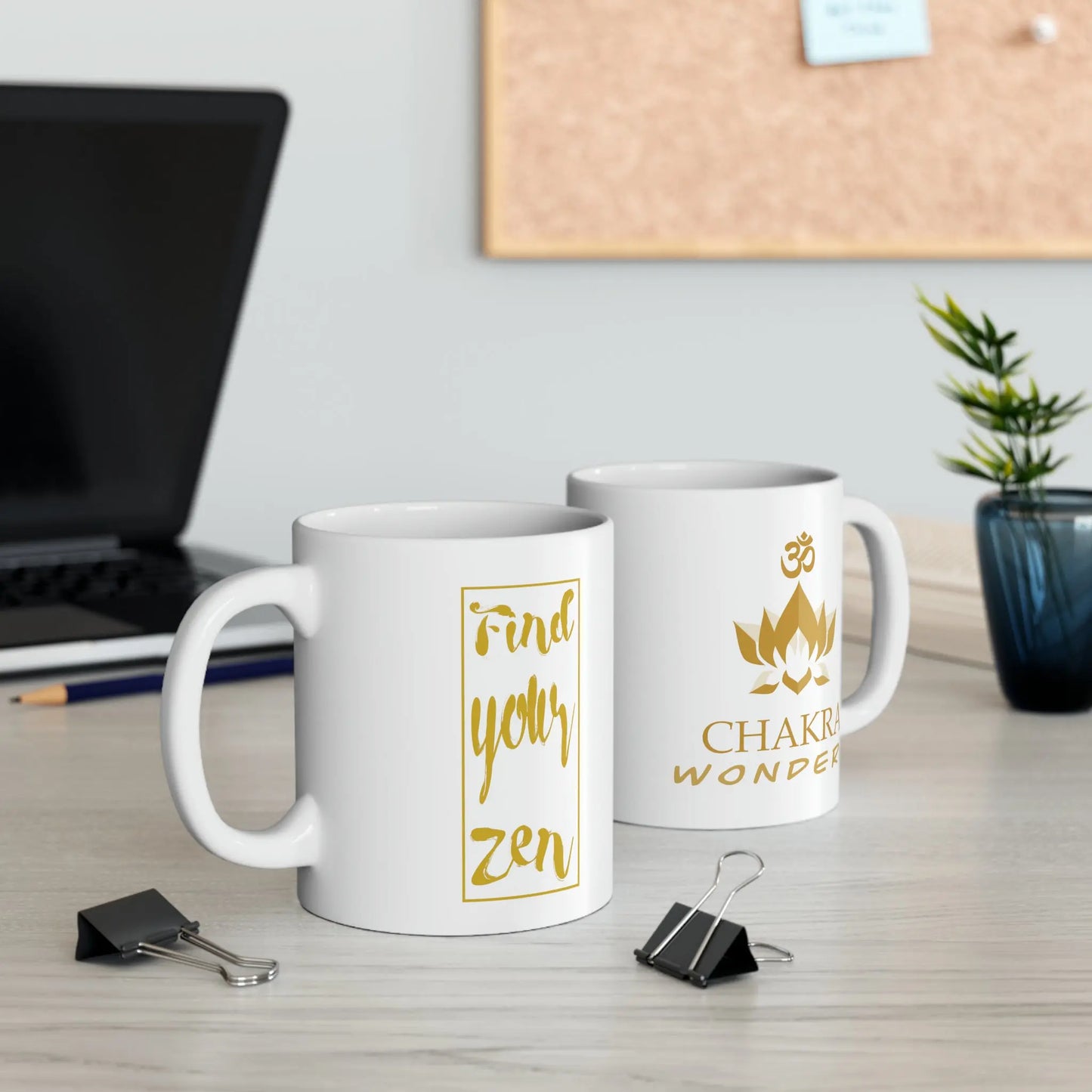 Two Chakra Wonders Mugs on a desk, showing both the logo side and the "Find your zen" text side.