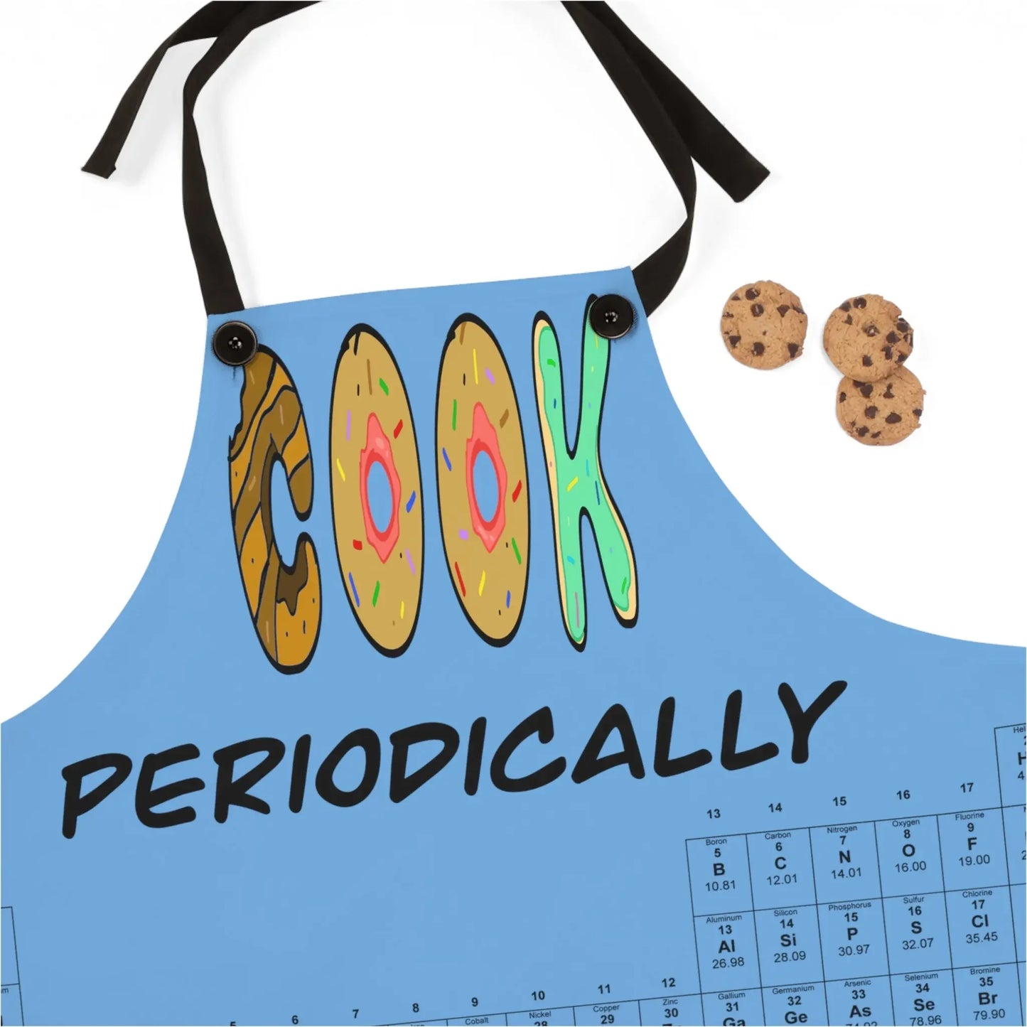 Blue apron with 'COOK PERIODICALLY' text, donut letters, periodic table design, and chocolate chip cookies