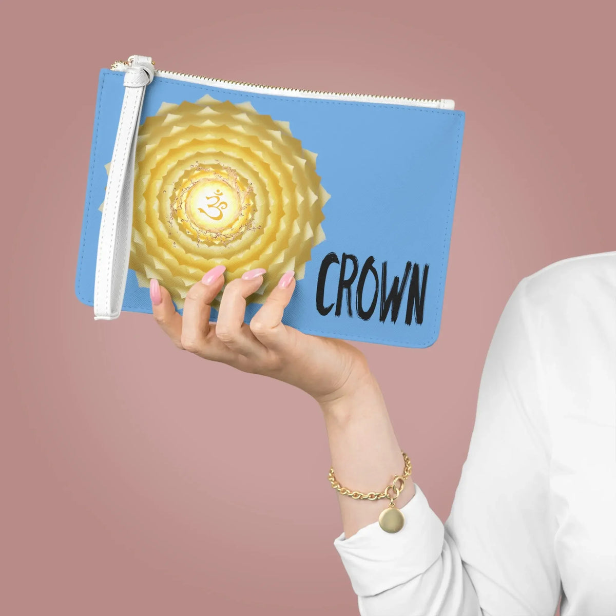 Blue pouch with golden crown chakra design and 'CROWN' text, held in hand for spiritual wellness