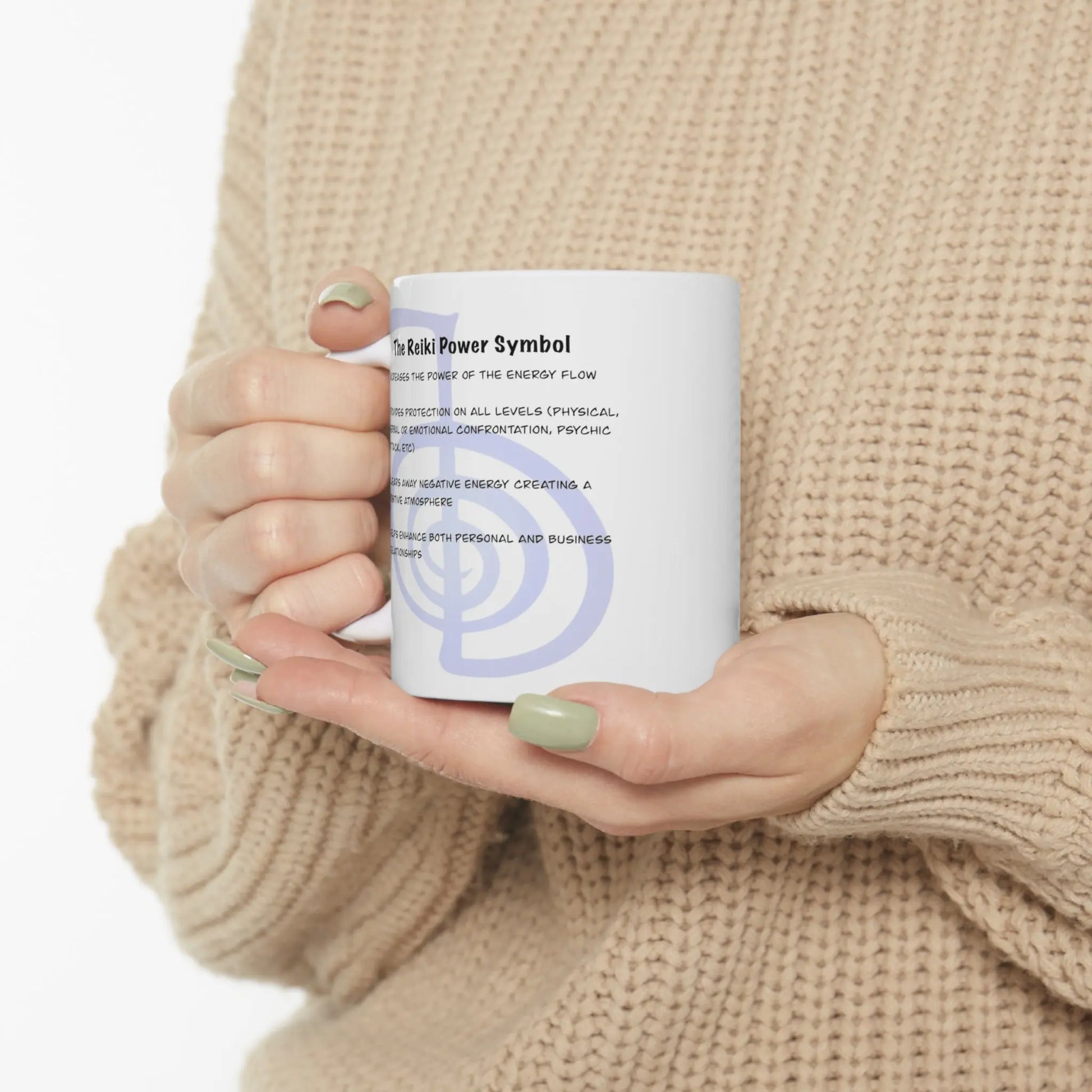 Person holding the Cho Ku Rei Reiki Mug, showing the Power Symbol description side.