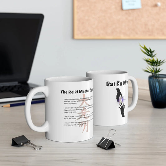 Two Dai Ko Myo Reiki Mugs on a desk with a laptop in the background.