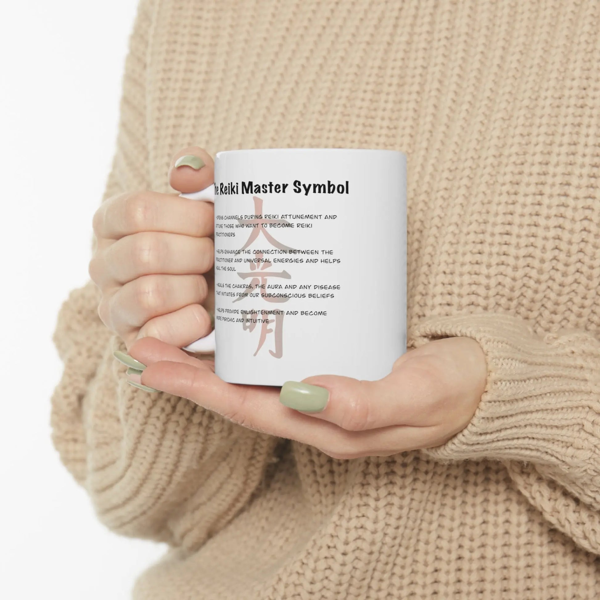 Person holding the Dai Ko Myo Reiki Mug, showing the Master Symbol description side.