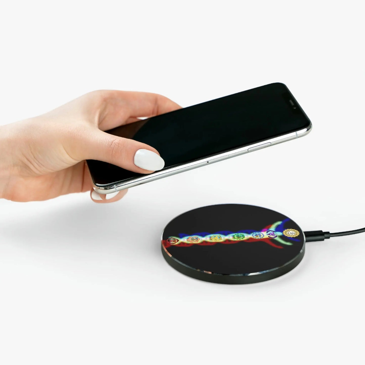 Person placing a phone onto the "DNA Man" Wireless Charger.