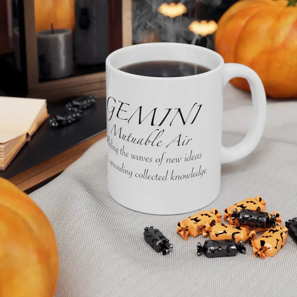 Gemini astrology mug with 'Mutable Air' text, surrounded by pumpkins and Halloween candy, perfect for zodiac lovers.