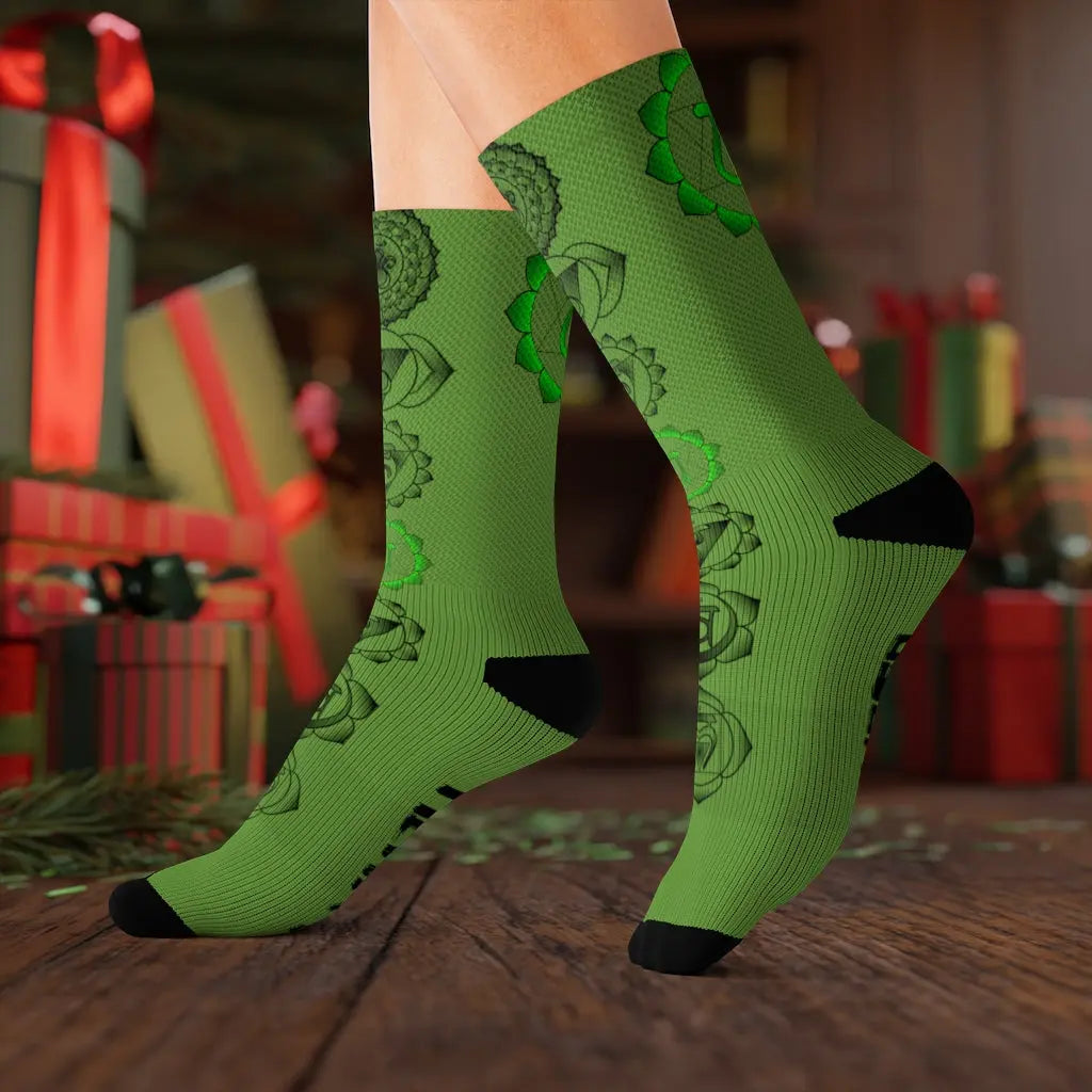 Model (Lifestyle): Model wearing the vibrant green Heart Chakra socks in a festive setting with wrapped holiday gifts in the background.