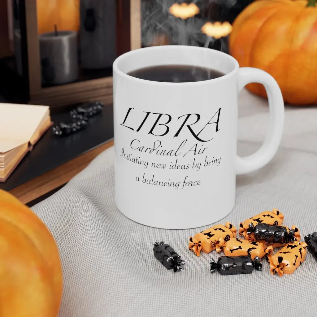 Libra astrology mug with cardinal air quote, surrounded by pumpkins and Halloween candy