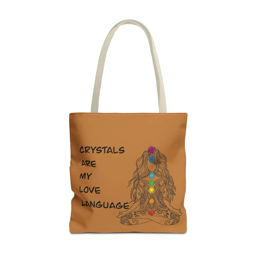 Crystal Love Language Tote Bag - Front view on a brown canvas showing the text "Crystals are my love language" and a meditating woman with chakras.