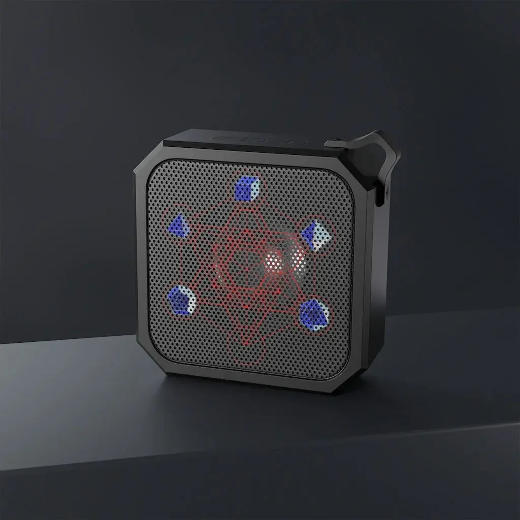 Black portable speaker with glowing chakra energy design and blue LED accents on dark surface