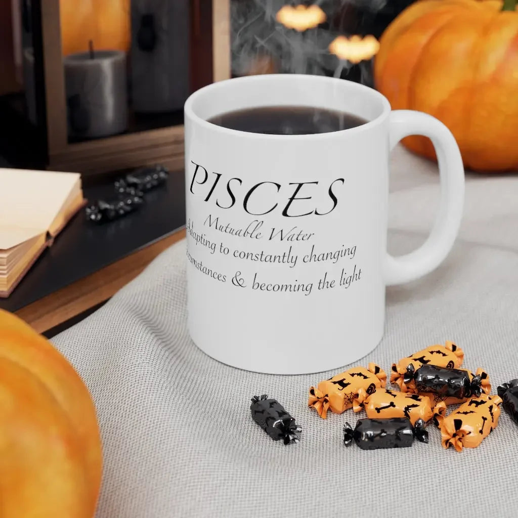 Pisces astrology mug with mutable water zodiac quote, surrounded by Halloween candy and pumpkins