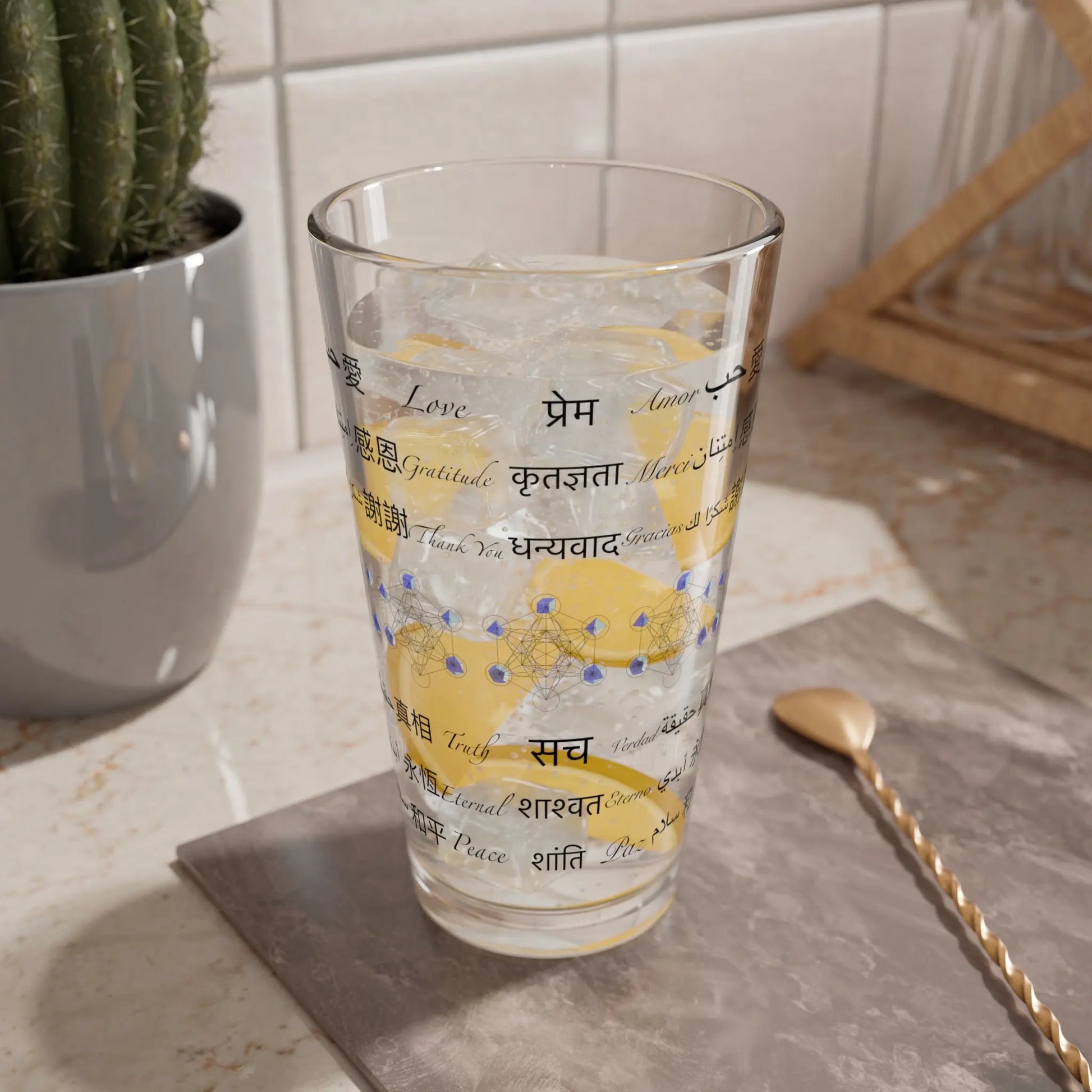 Alternate lifestyle view of the Power of Words Pint Glass with its intricate design.