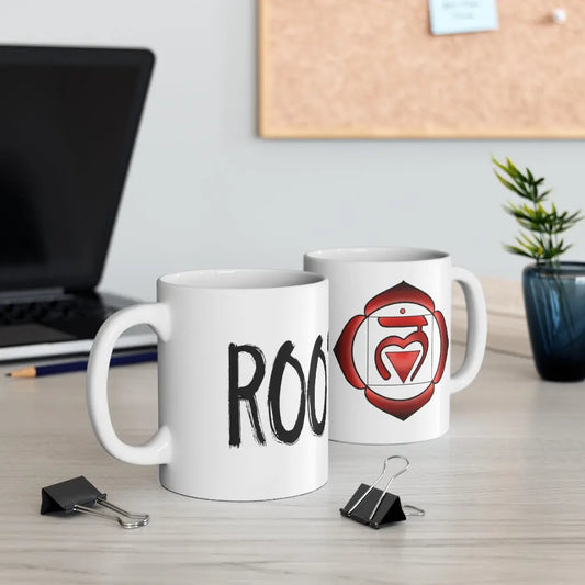 Two Root Chakra Mugs on a desk, showing both the "ROOT" text side and the chakra symbol side.