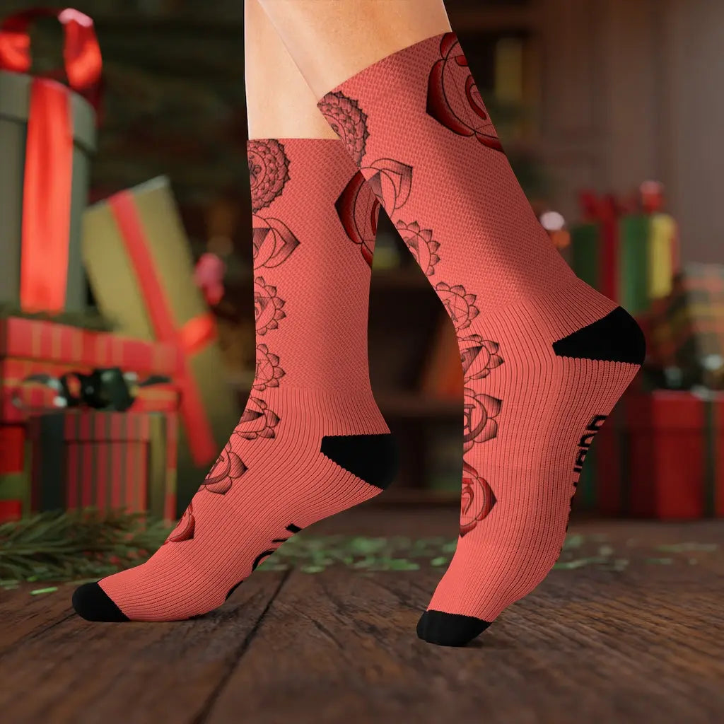 Lifestyle (Holiday Gift): Model wearing the Root Chakra Socks in a festive Christmas setting, presenting them as a thoughtful and unique holiday gift for wellness enthusiasts.