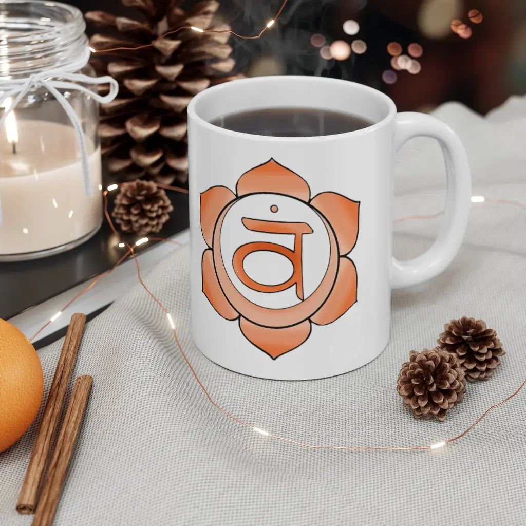 Sacral Chakra Mug - Symbol side with a cozy, winter-themed background.