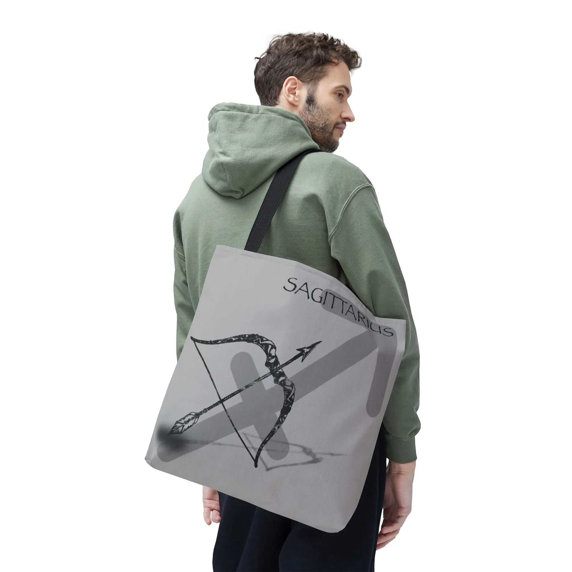 Man carrying the Sagittarius Zodiac Tote Bag to show scale and style.