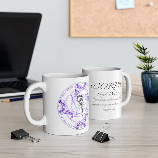 Two Scorpio Zodiac Mugs on a desk, showing both the quote side and the elemental sigil side.