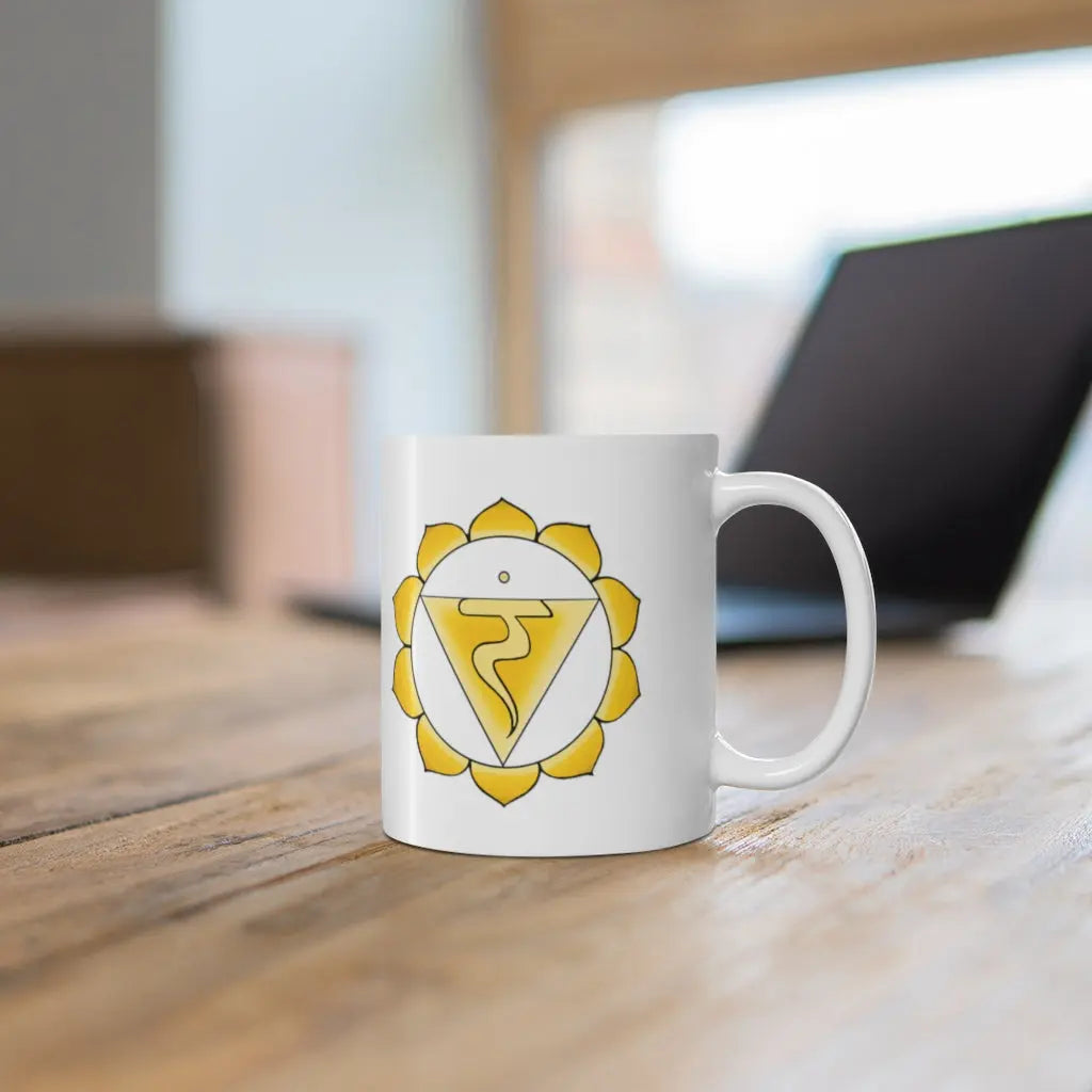 Solar Plexus Chakra Mug - Symbol side shown on a wooden desk with a laptop.