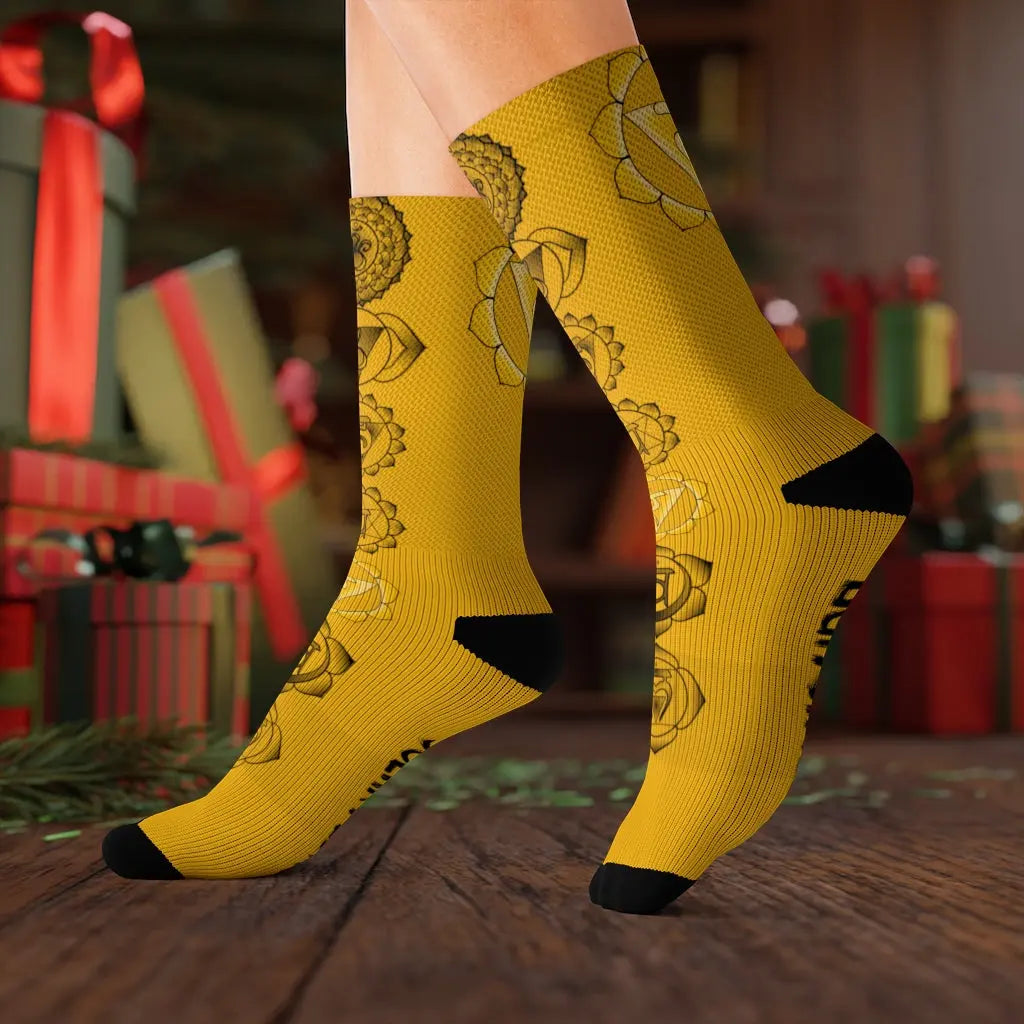 Model (Lifestyle): Model wearing the vibrant yellow Solar Plexus Chakra socks in a festive setting with wrapped holiday gifts in the background.