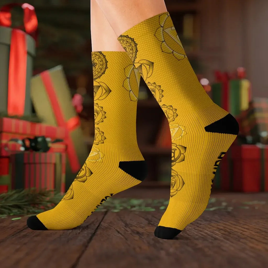 Yellow chakra socks with lotus designs, festive gift background, metaphysical wellness apparel