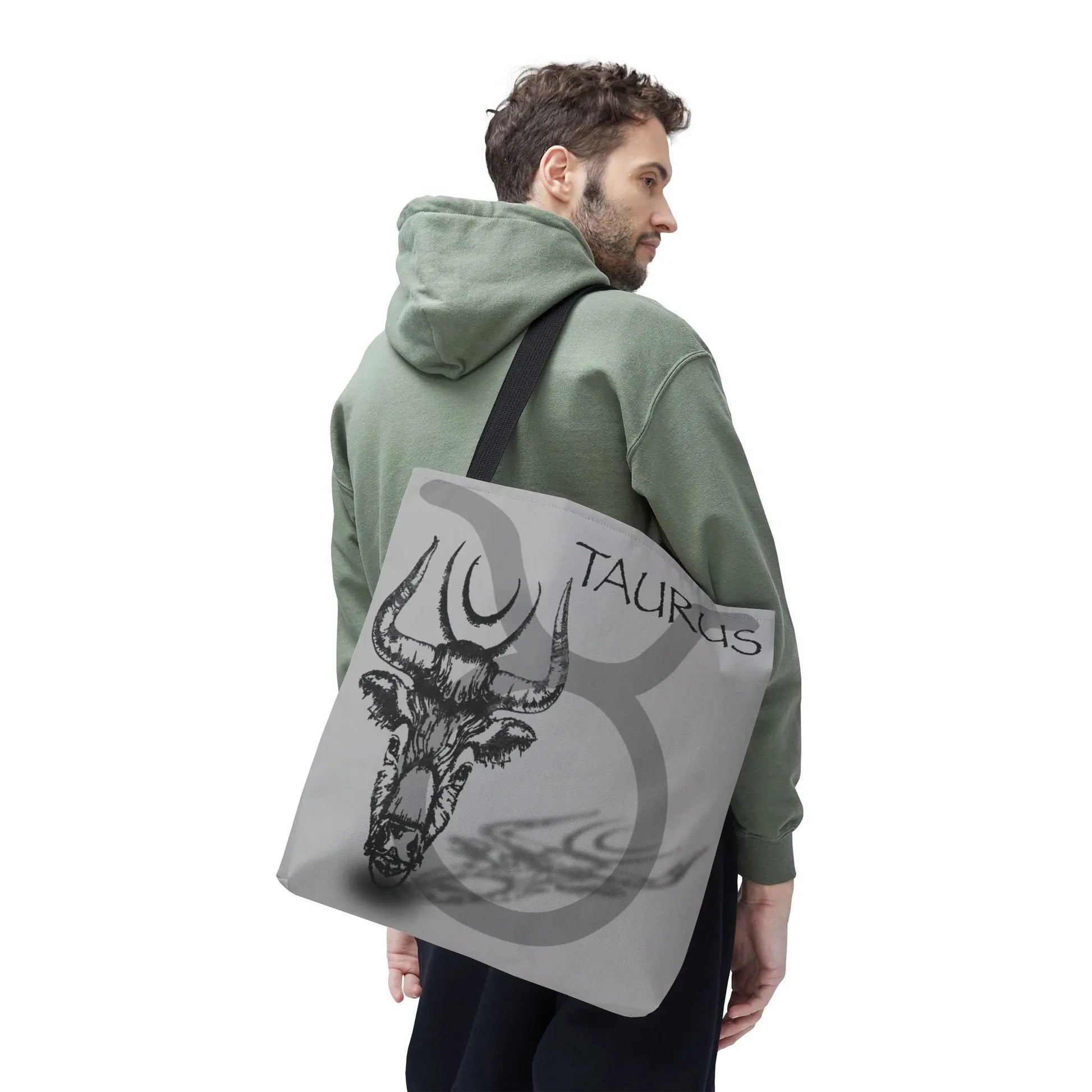 Man carrying the Taurus Zodiac Tote Bag to show scale and style.
