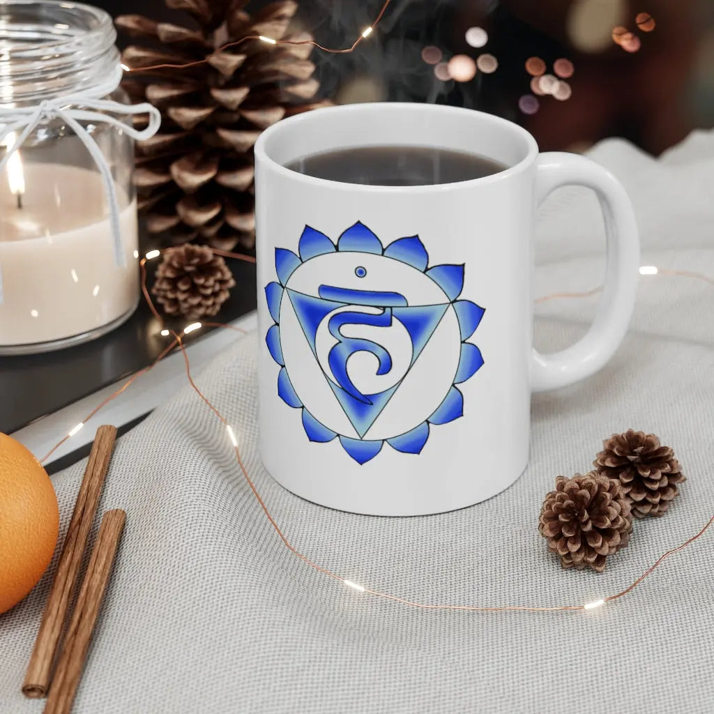 Throat Chakra Mug - Symbol side with a cozy, winter-themed background.