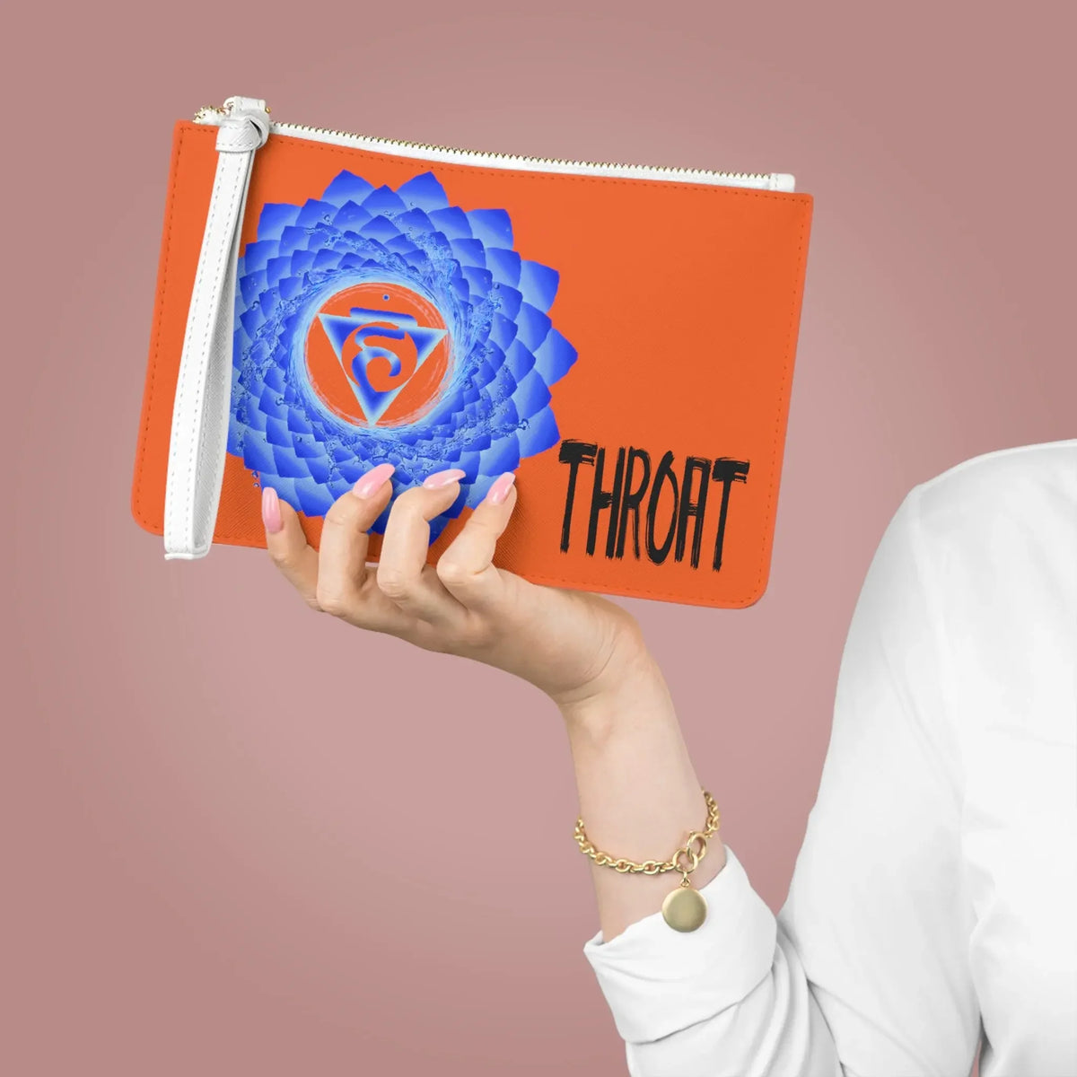 Orange pouch with blue Throat Chakra symbol and 'THROAT' text, held in hand for spiritual wellness.