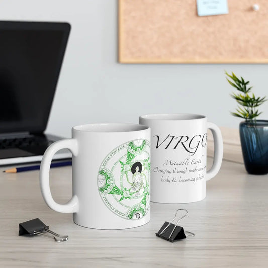 Two Virgo Zodiac Mugs on a desk, showing both the quote side and the elemental sigil side.