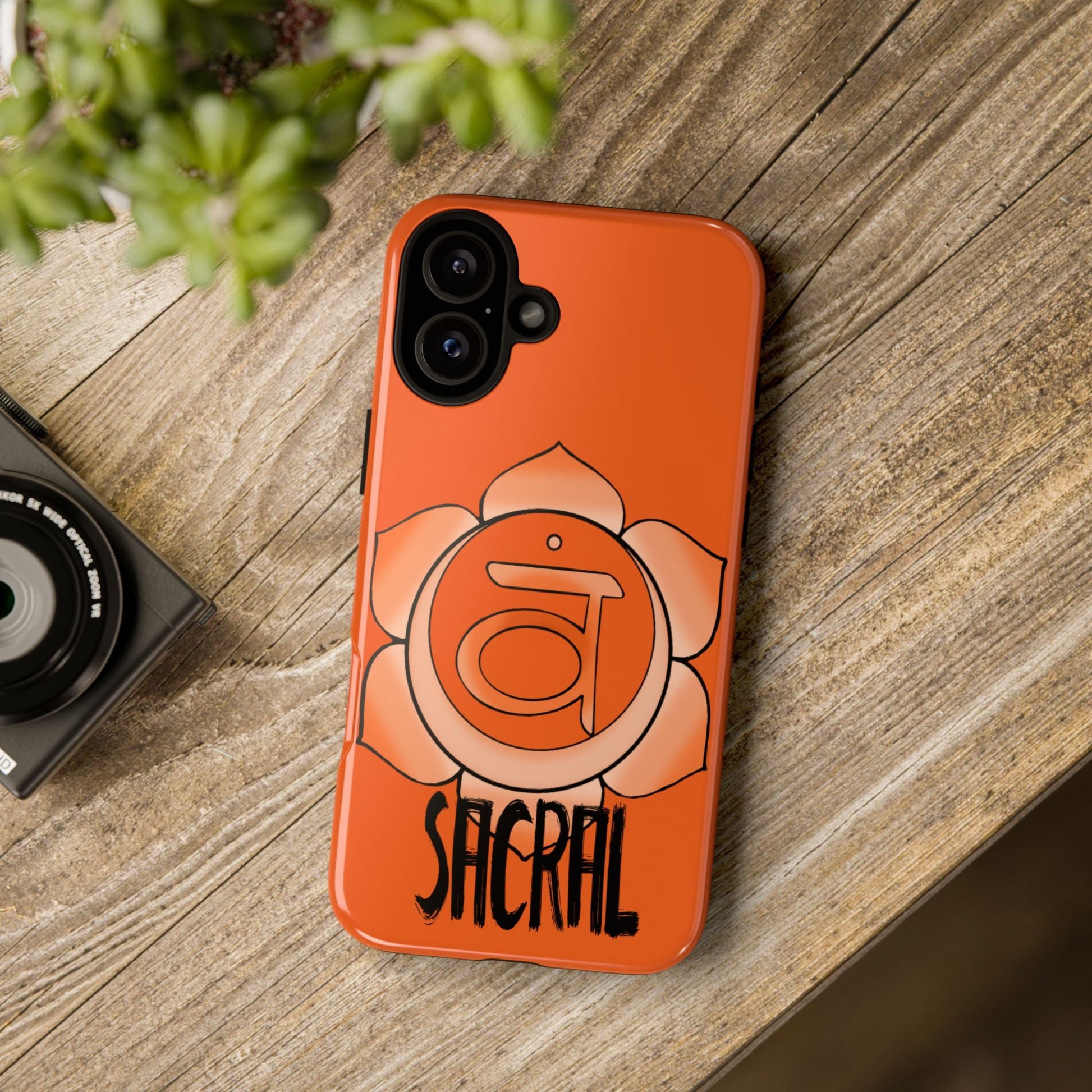 Sacral Chakra Phone Case - Svadhisthana on a wooden table 