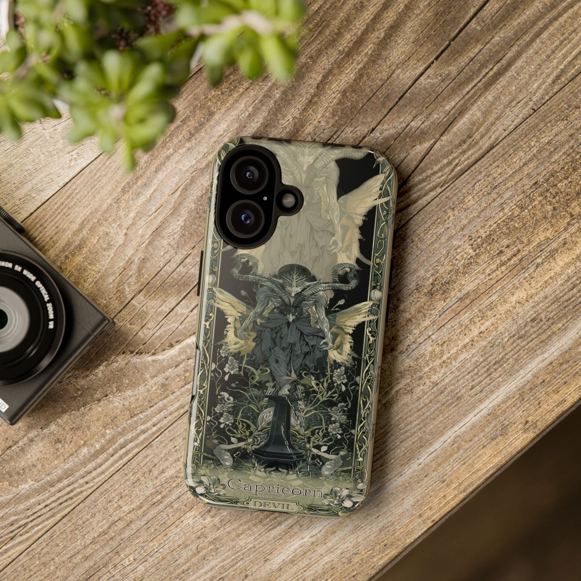Capricorn "The Devil" Tarot Card Phone Case iPhone 17 on wooden table