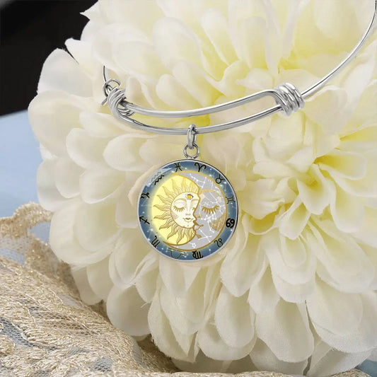 Silver Celestial Zodiac Bangle Bracelet on a white flower.